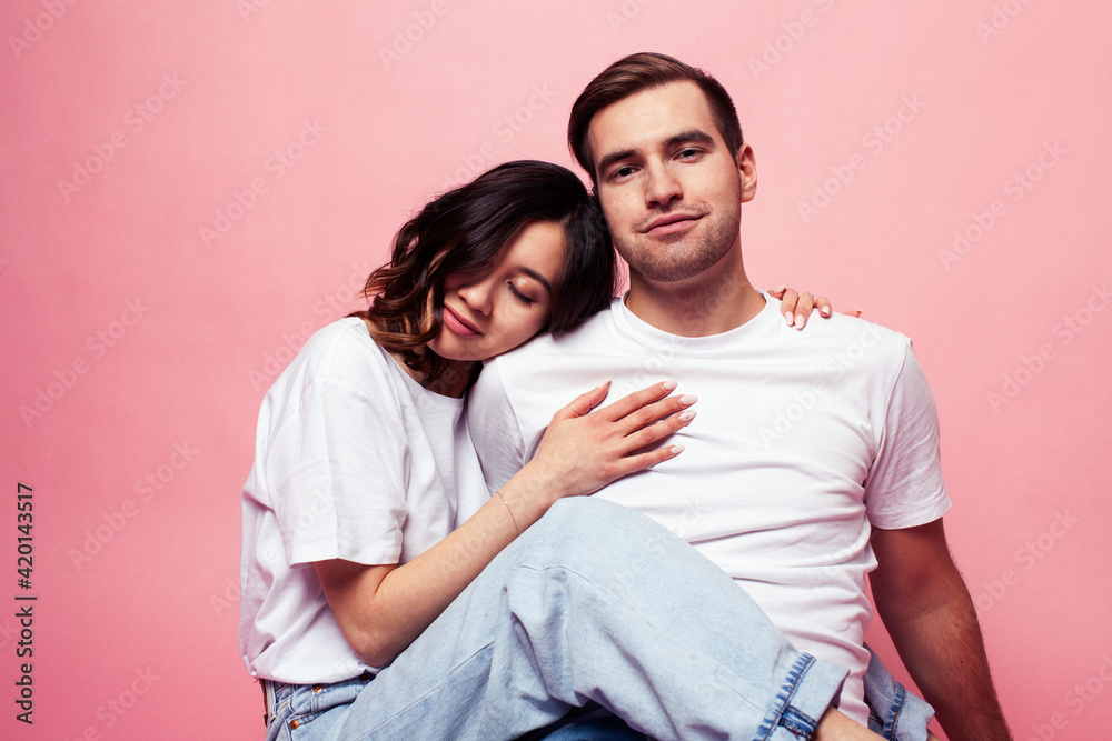 young cheerful caucasian couple together having fun on pink background, guy ang girl modern relationship, lifestyle people concept young cheerful caucasian couple together having fun on pink background, guy ang girl modern relationship, lifestyle people concept