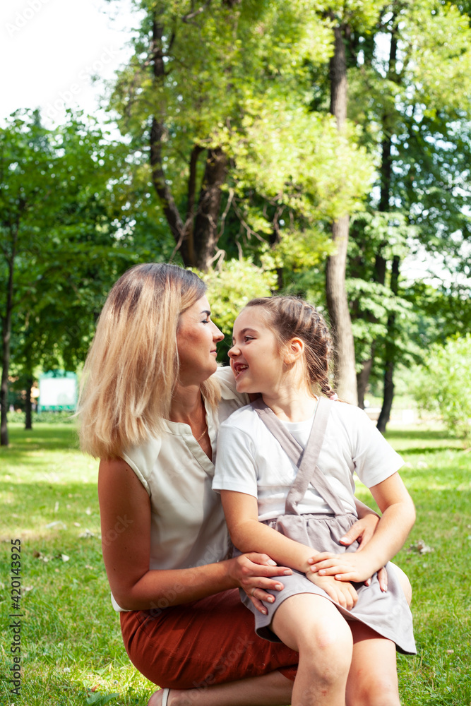 Fototapeta premium young pretty mother walking with little cute daughter outside in green park, lifestyle poeple concept