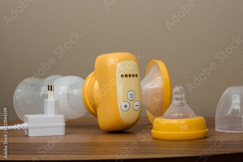breast pump yellow on a wooden table