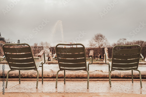 Paris, France 13-03-2021: three chairs alone in the Tuilerie garden
