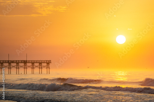 Sunrise Above a Boardwalk and Waves © Benjamin