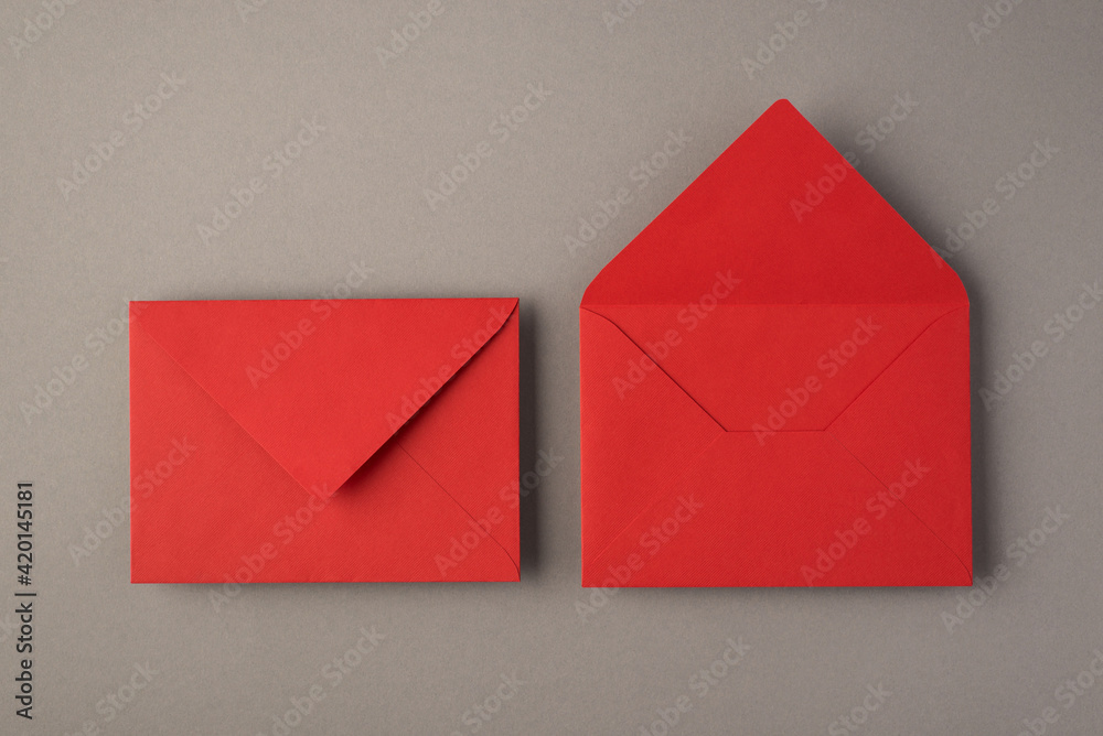Above photo of two bright red envelopes isolated on the grey background