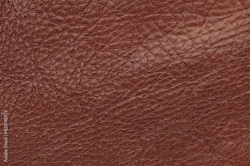 Surface of the brown glossy leather background texture. Top view. Close up.