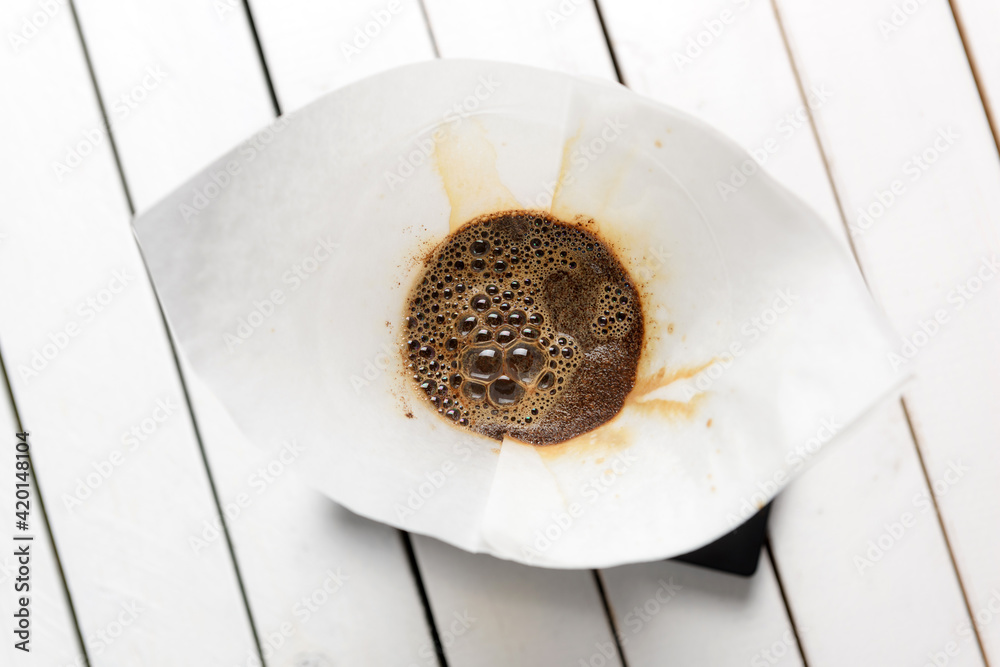 Process of brewing coffee using the drip method. Pouring ground coffee