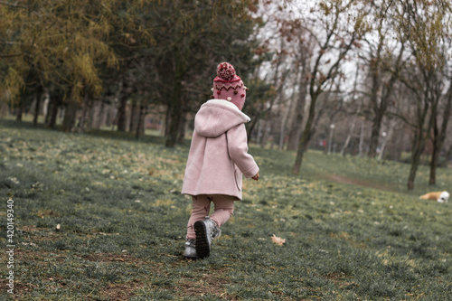 Baby girl walking in the park 