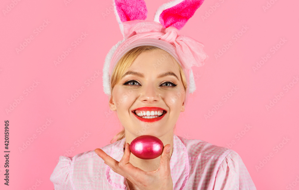 Rabbit girl. Easter day. Happy Woman with bunny ears holds pink Easter egg. Eggs hunt. Spring holidays. Rabbit girl. Easter day. Happy Woman with bunny ears holds pink Easter egg. Eggs hunt. Spring holidays.
