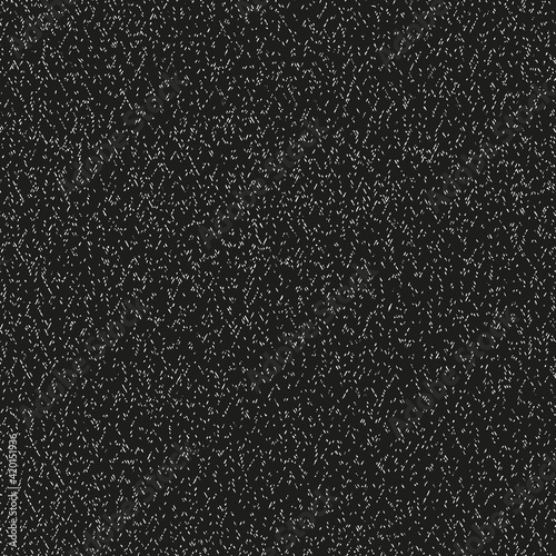 Abstract grainy grunge vector texture as seamless pattern with black background.