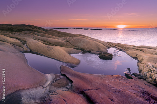 Sunset on skerries in Ytre Hvaler National Park, on the island of Kirkeoy in Norway