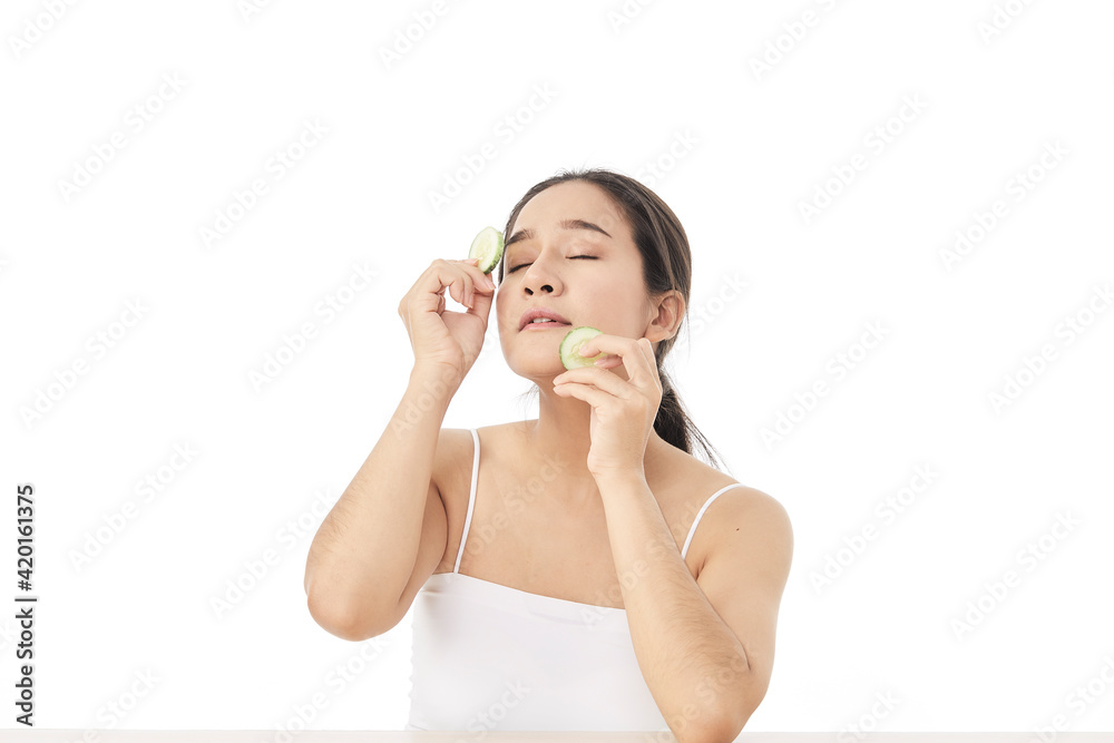 Beautiful young asian woman with cucumber slices Beautiful young asian woman with cucumber slices
