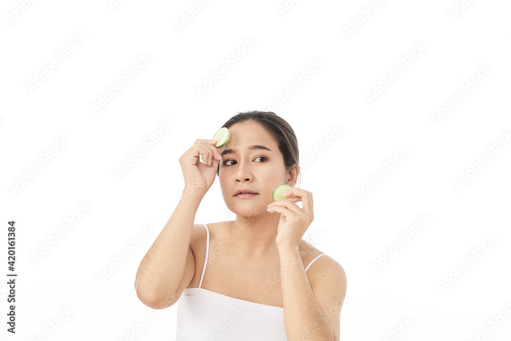 Beautiful young asian woman with cucumber slices Beautiful young asian woman with cucumber slices