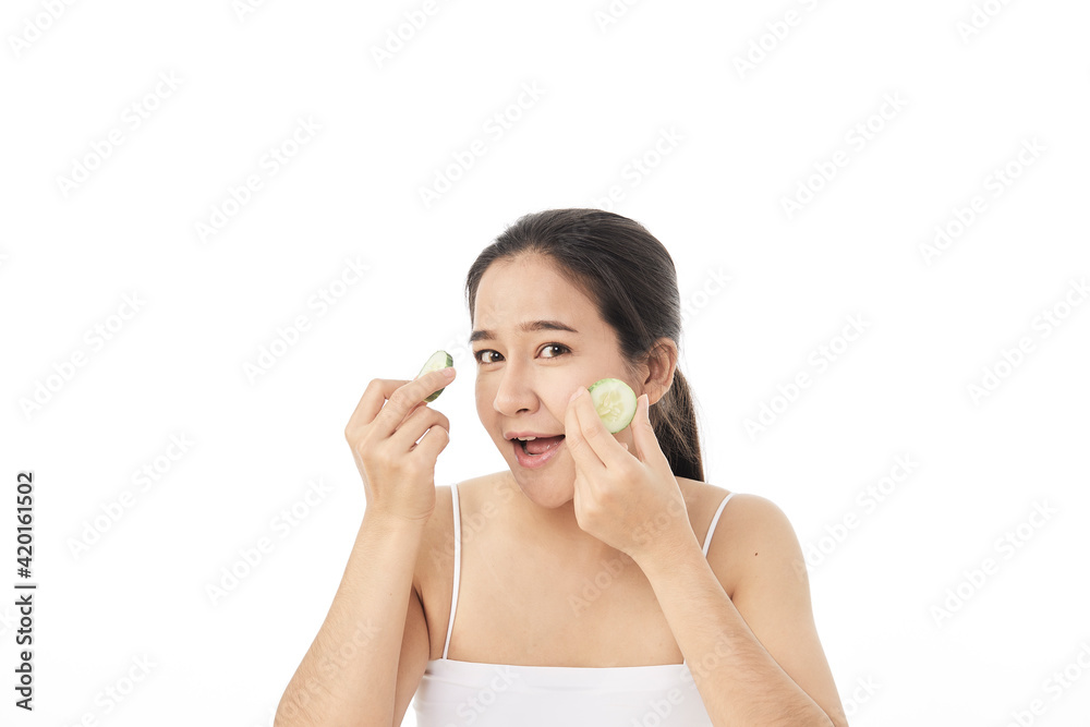 Beautiful young asian woman with cucumber slices Beautiful young asian woman with cucumber slices