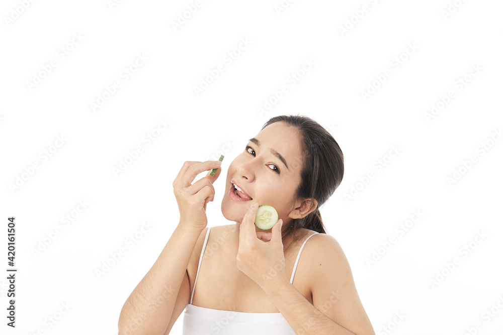 Beautiful young asian woman with cucumber slices Beautiful young asian woman with cucumber slices