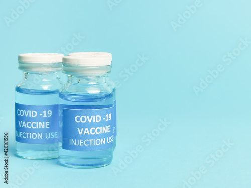 Selective focus COVID 19 VACCINE isolated on bluish background. 