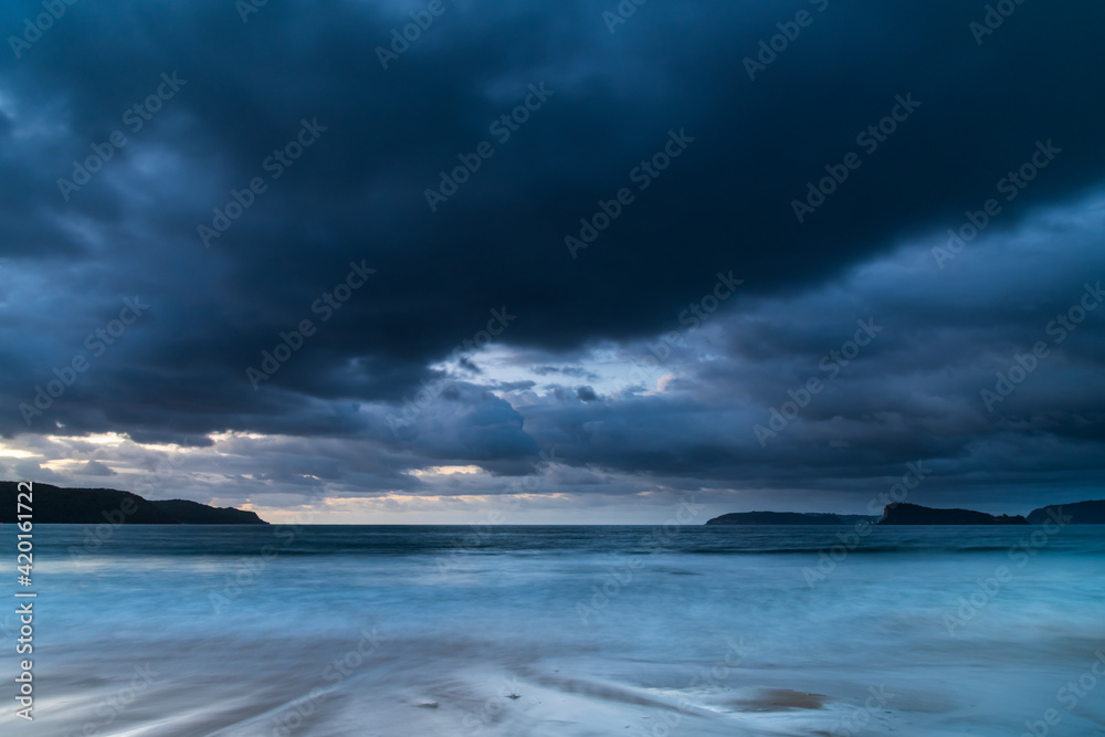 Drizzly sunrise seascape with seaweed on the beach Drizzly sunrise seascape with seaweed on the beach