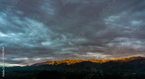 mountains at sunset with totally cloudy gray sky in the shape of cotton