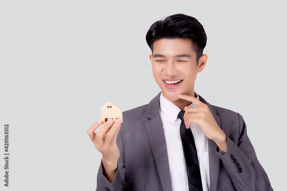 Young asian business man thinking idea and holding the home symbol of planning saving for future, insurance agent and credit, debt and loan of finance, home and refinance, investment real property. Young asian business man thinking idea and holding the home symbol of planning saving for future, insurance agent and credit, debt and loan of finance, home and refinance, investment real property.