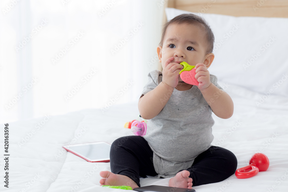 Portrait of cute little baby girl sitting with cozy on bed at bedroom, happiness of toddler, newborn 6-11 months with innocence and expression with cheerful, child charm, indoors, one person. Portrait of cute little baby girl sitting with cozy on bed at bedroom, happiness of toddler, newborn 6-11 months with innocence and expression with cheerful, child charm, indoors, one person.