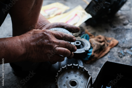 Motorcycle mechanics are assembling the motorcycle engine clutch assembly and maintenance.