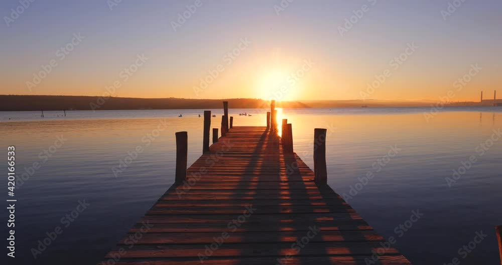 Sunset Over the lake and wooden old pier, 4k video