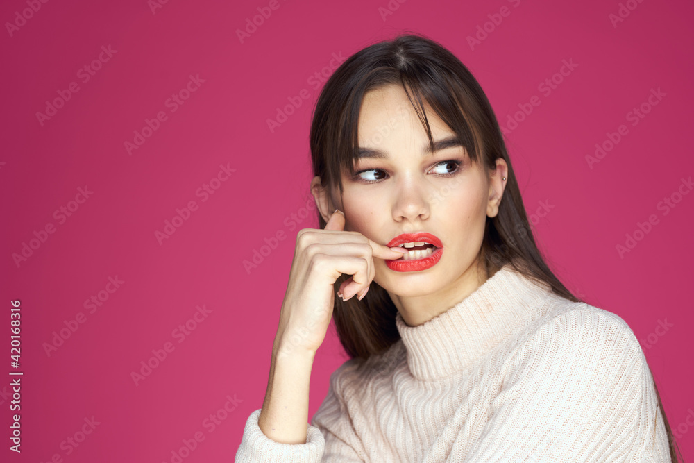 Woman with long hair and red lips white blouse pink background attractive look