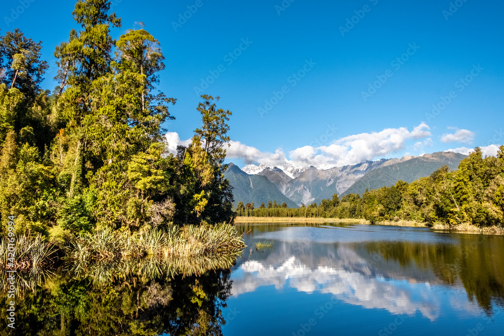 The Southern Alps reflecting in Matheson Lake. South Island, New Zealand.