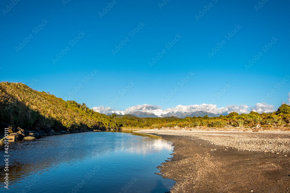 The empty beach of a quiet river. South Island, New Zealand.