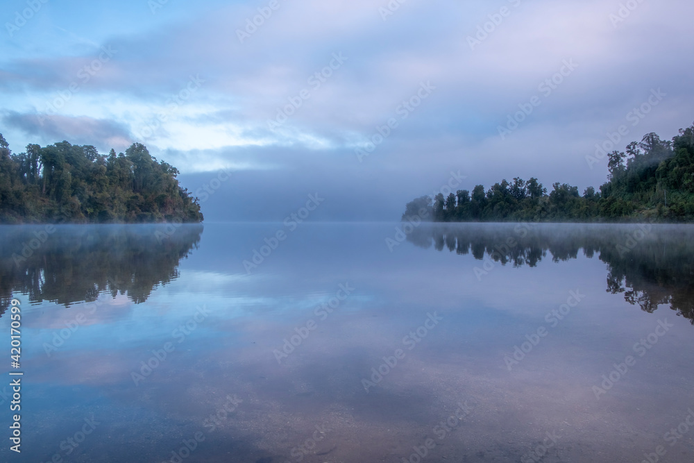 Morning fog over a beautiful lake. South Island, New Zealand.