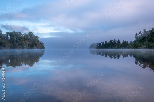 Morning fog over a beautiful lake. South Island  New Zealand.