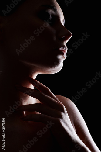 Beautiful Woman silhouette in the dark photo