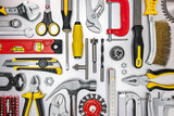 different kinds of work tools on grey metal background. view from above