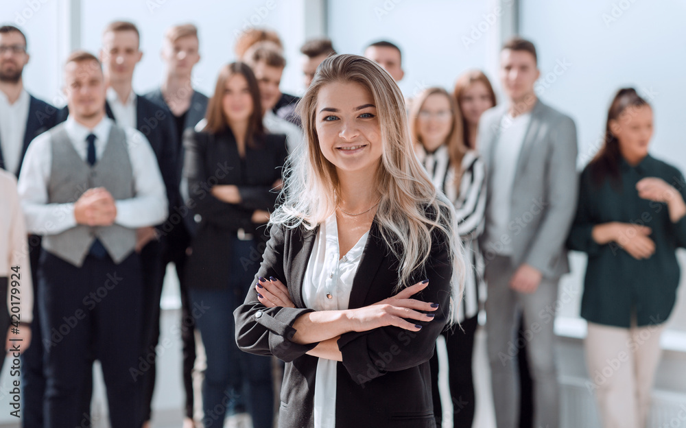 ambitious young business woman standing in front of her colleagues ambitious young business woman standing in front of her colleagues