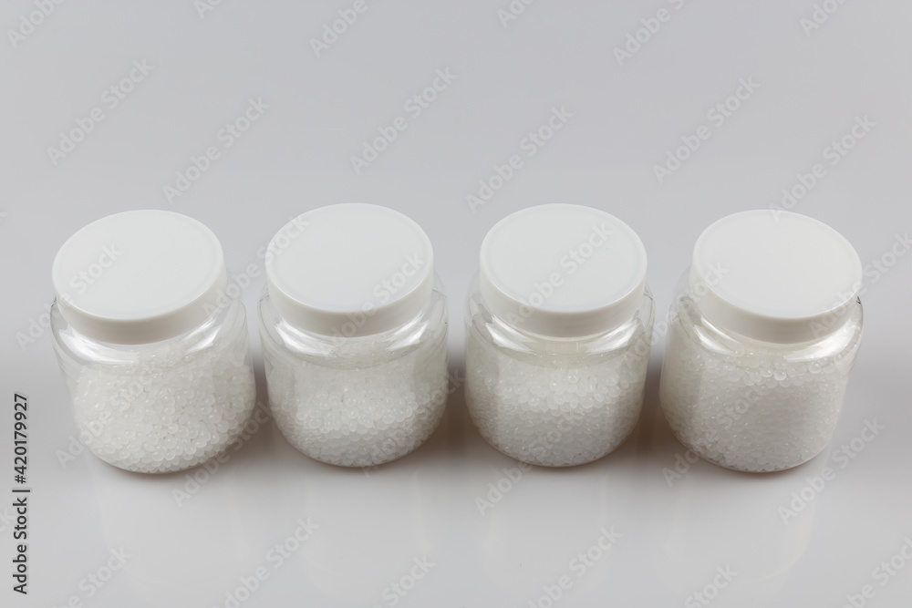 Transparent bottle inside with plastic beads. white polymer. white plastic beads. Transparent bottle inside with plastic beads. white polymer. white plastic beads.