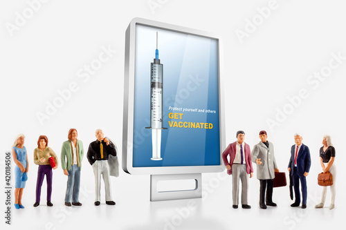 a group of different age people are standing in front of a billboard with a message to get vaccinated against covid-19