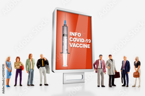a group of different age people are standing in front of a billboard with information about the covid-19