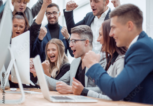 jubilant business team looking at the computer monitor