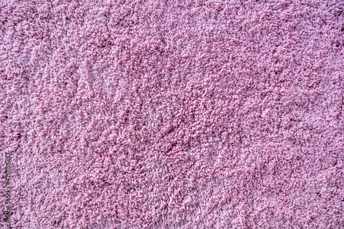 Long pile carpet texture. Abstract background of shaggy pink fibers.