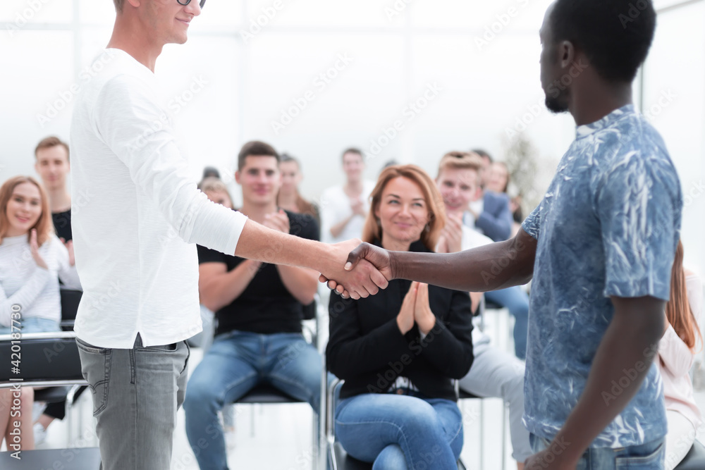 Fototapeta premium young men shake hands before the start of the briefing