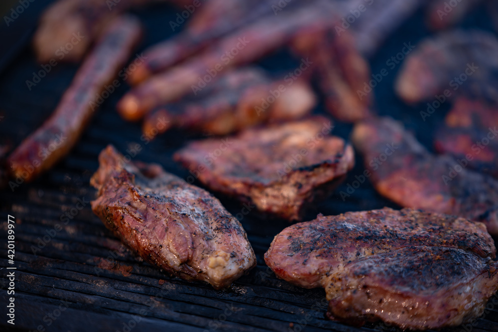 roasted chicken and pork steak with sausages. grilled meat cooked and smoked roasted chicken and pork steak with sausages. grilled meat cooked and smoked