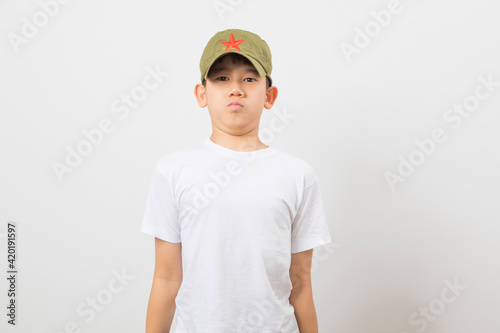 Asian boy wearing a Chinese Chairman Mao Zedong Communist Red Army Hat on white background. photo