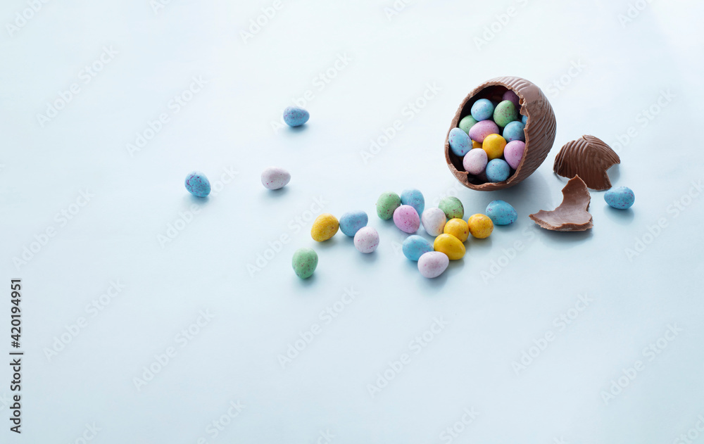 Egg shaped candies in broken chocolate easter egg Egg shaped candies in broken chocolate easter egg