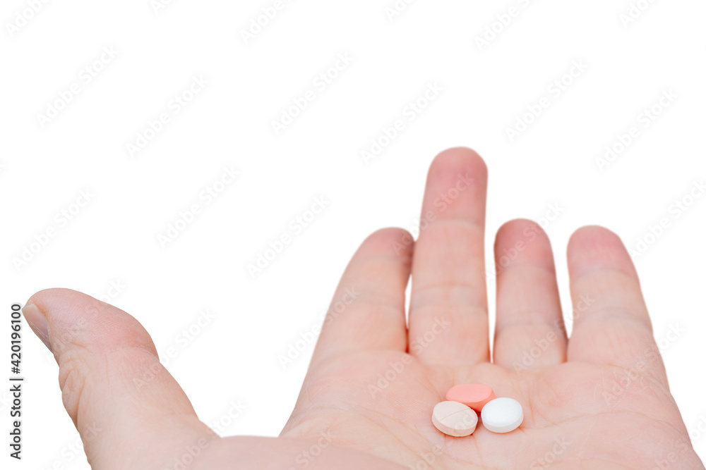 White and pink pills in the palm of your hand. Treatment with pills. White and pink pills in the palm of your hand. Treatment with pills.