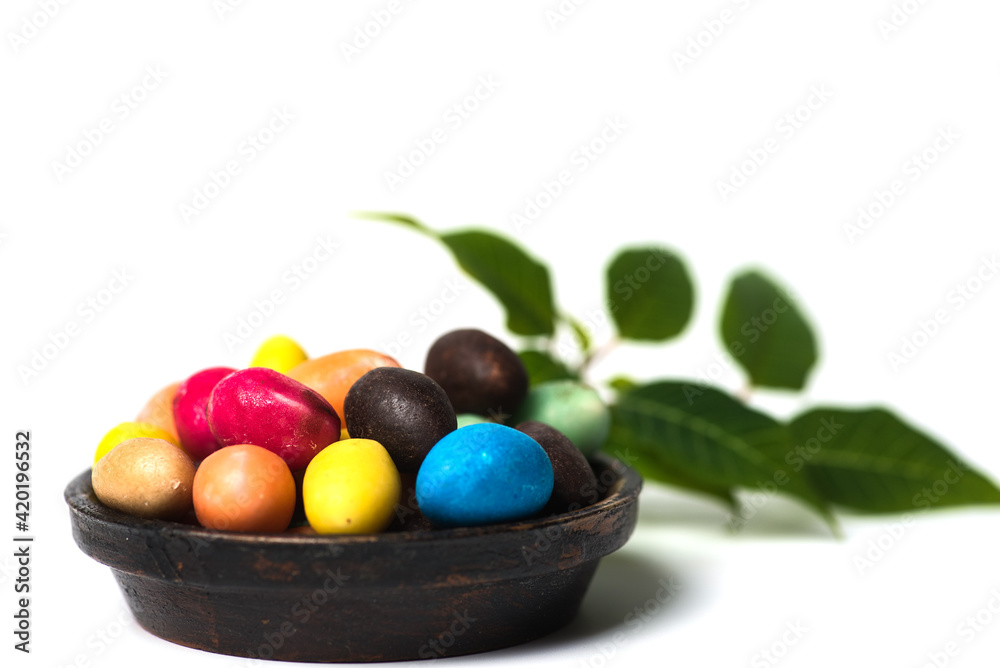 Chocolate Easter eggs with egg candies on white background Chocolate Easter eggs with egg candies on white background