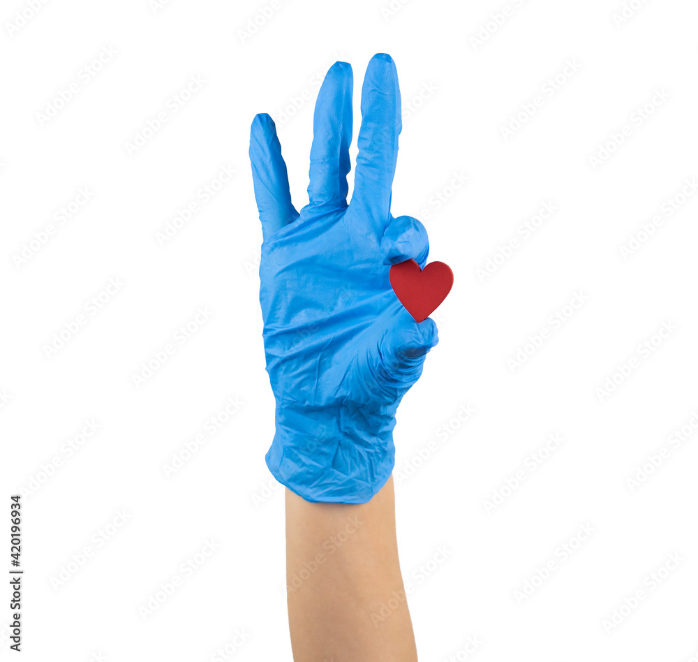 hand in blue medicine glove holding wooden red heart with two fingers showing it isolated on white background hand in blue medicine glove holding wooden red heart with two fingers showing it isolated on white background