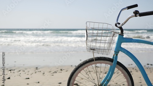 Schilderij op canvas Blue bicycle, cruiser bike by ocean beach pacific coast, Oceanside California USA