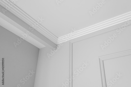 Detail of corner ceiling cornice with intricate crown moulding. photo