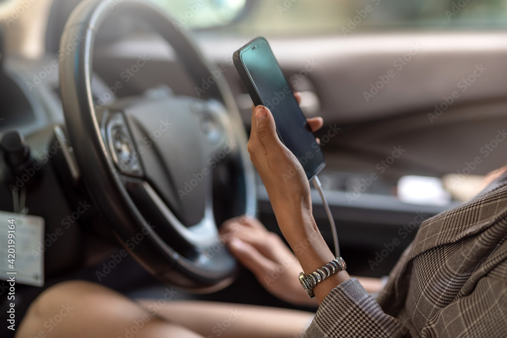 Woman using a smartphone while driving danger.