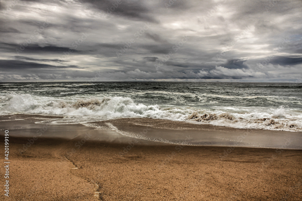Brave ocean, rock formations and cloudy drama sky on the beach Brave ocean, rock formations and cloudy drama sky on the beach