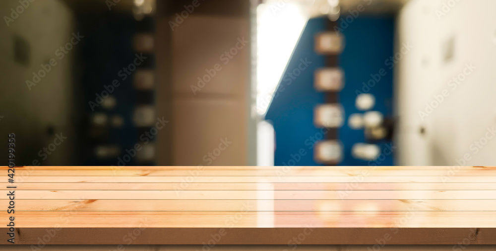Empty wooden table top with lights bokeh on blur restaurant background. Empty wooden table top with lights bokeh on blur restaurant background.