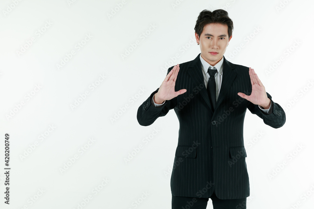 Portrait of self-confidence young and handsome Asian businessman in black suit standing and raise hands for explaining and clarifying, copy space studio shot isolated on white background Portrait of self-confidence young and handsome Asian businessman in black suit standing and raise hands for explaining and clarifying, copy space studio shot isolated on white background