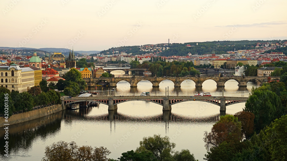 Historic bridges in Prague aerial view, famous popular tourist destination, guided tour concept, Charles Bridge sunset cityscape, Prague, Czech Republic